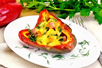 Image showing Pepper stuffed with sausage and cheese on table