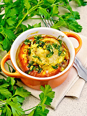 Image showing Fish baked with tomato and garlic in red pot on table