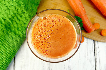 Image showing Juice carrot with vegetables and napkin on board top