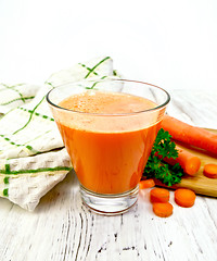 Image showing Juice carrot with vegetables and napkin on light board