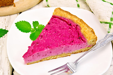 Image showing Pie of black currants with mint in plate on board