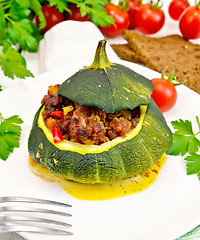 Image showing Squash green stuffed with meat on light board