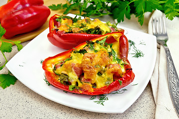 Image showing Pepper stuffed with sausage and cheese in plate on table