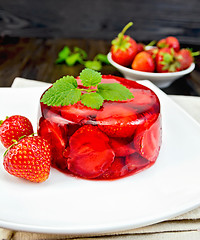 Image showing Jelly strawberry with mint and berries on dark board