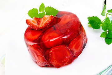 Image showing Jelly strawberry with mint on napkin and light board