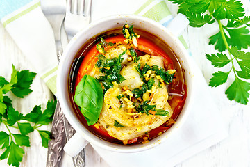 Image showing Fish baked with tomato in white bowl on board top