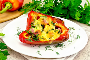 Image showing Pepper stuffed with sausage and cheese in plate on stone table