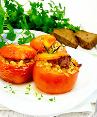 Image showing Tomatoes stuffed with bulgur in plate on light board