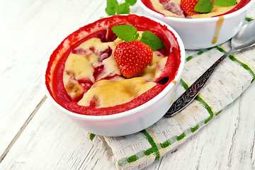 Image showing Pudding strawberry in two bowls on light board