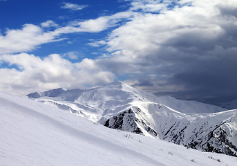 Image showing Ski slope in evening and storm clouds