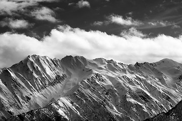 Image showing Black and white snow winter mountains and cloud sky in sun eveni