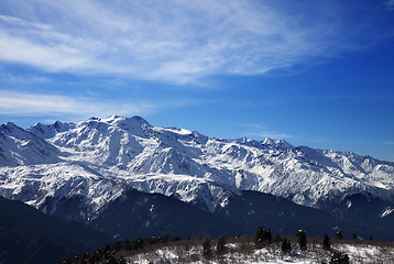Image showing Sunlight snow mountains and cloudy sky in wind winter day