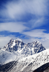 Image showing Mounts Ushba and Chatyn and blue sky with clouds in winter wind 