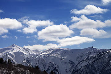 Image showing Sunlight snow mountains and blue sky with clouds