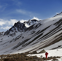 Image showing Hiker at snowy mountains in sun evening