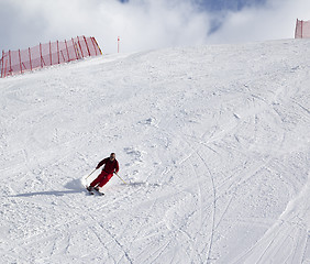 Image showing Skier on ski slope at sun day