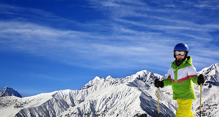 Image showing Young skier with on snow mountains at sun winter day