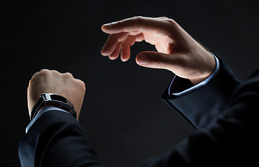 Image showing close up of businessman hands with smart watch