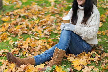 Image showing close up of woman drinking coffee in autumn park