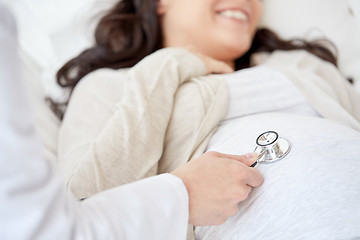 Image showing doctor with stethoscope and pregnant woman