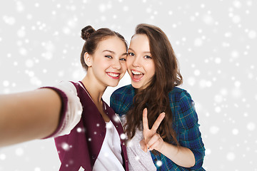 Image showing happy friends taking selfie and showing peace