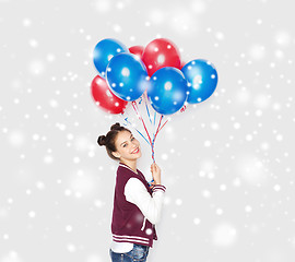 Image showing happy teenage girl with helium balloons over snow