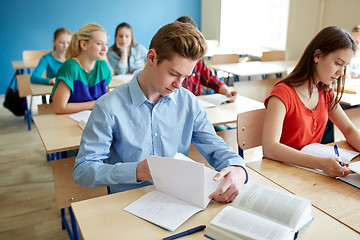 Image showing group of students with books at school lesson