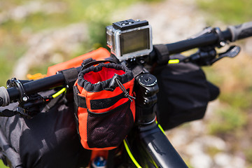 Image showing Bicycle with orange bags for travel