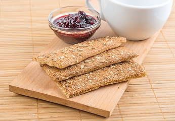 Image showing Crispbread and jam. On a wooden stand.
