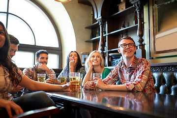 Image showing friends with beer watching football at bar or pub