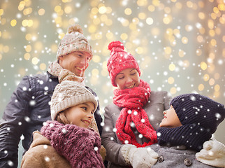 Image showing happy family over christmas lights and snow