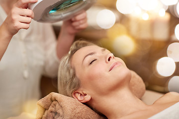 Image showing close up of young woman lying in spa