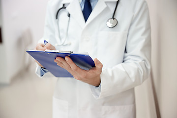 Image showing close up of doctor with clipboard at hospital