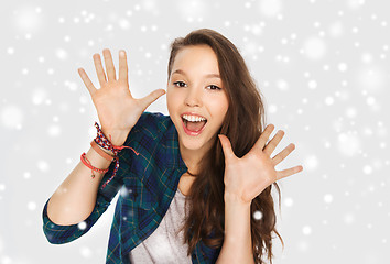 Image showing happy laughing pretty teenage girl showing hands