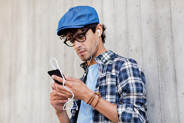 Image showing man with earphones and smartphone listening music