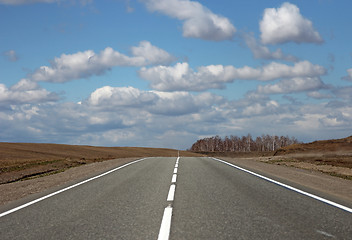 Image showing Asphalt road and clouds on blue sky in sunny day