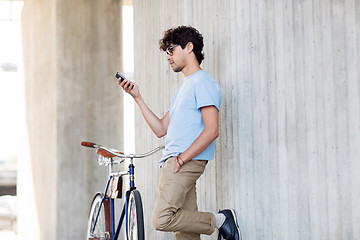 Image showing man with smartphone and fixed gear bike on street