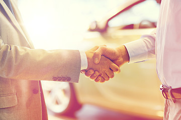 Image showing close up of male handshake in auto show or salon