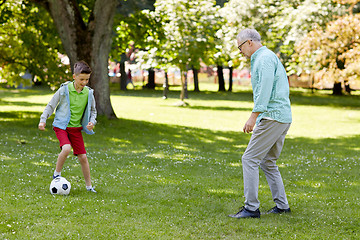 Image showing old man and boy playing football at summer park