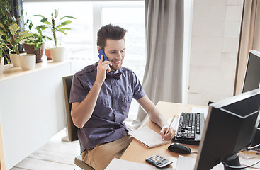 Image showing happy creative male worker calling on smarphone
