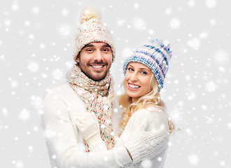 Image showing smiling couple in winter clothes hugging