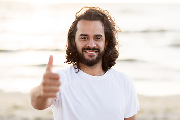 Image showing happy smiling man with beard on beach