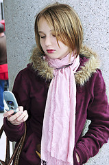 Image showing Teenage girl text messaging on cell phone