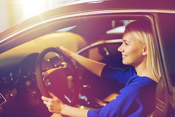 Image showing happy woman inside car in auto show or salon