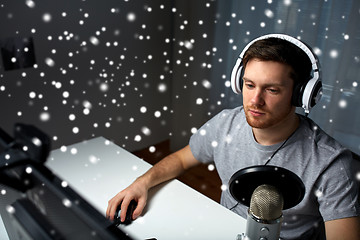 Image showing man in headset playing computer video game at home