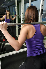 Image showing Woman doing shoulder exercise with weight bar