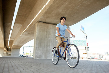 Image showing young hipster man riding fixed gear bike