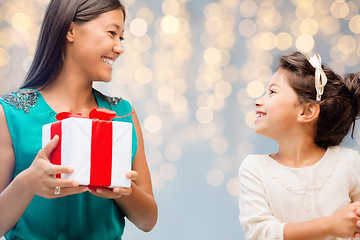 Image showing happy mother giving birthday present to her child