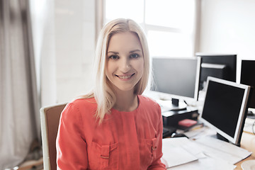 Image showing happy creative female office worker with computers