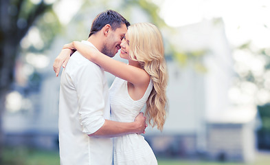 Image showing happy couple hugging over summer house background